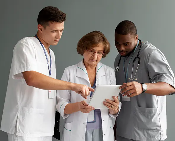 Healthcare professionals reviewing digital patient records for care coordination.