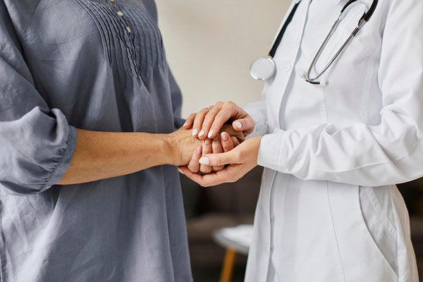 Compassionate provider holding a patient's hand at Haven Health Medical in Woodhaven.
